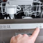 What Is The Symbol For Dishwasher Safe (Full Guide) Close Up Of Woman’s Hand Pressing Start Button On Dishwasher
