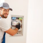 Does A Dishwasher Need A Dedicated Circuit? (Be Careful) technician working with fuses at the circuit breaker
