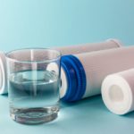 A glass of water on the background of filter cartridge