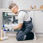 ZeroWater Filter Not Draining? - (6 Causes & Solutions) Plumber working replaceable dirty used aqua filter for filtration of reverse osmosis water